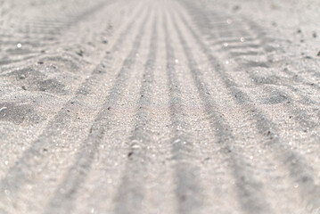 Close-up of a tire track in the sand