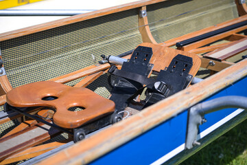 Wooden sliding seat and fixed footrest in a sport rowing boat built for races and regatta © Maren Winter