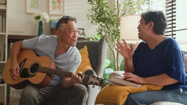 sweet Asian senior Couple sing play acoustic ukulele instrument. Happy Smiling Elderly grandparent having fun and enjoying their Retirement life. Lifestyle, Party happy lifestyle healhy insurance idea