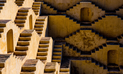 Exploring the ancient architectural pattern of stepwells in india, a symmetrical and intricate...