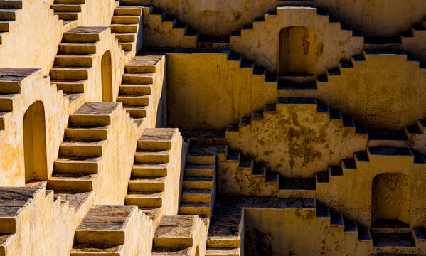 Exploring the ancient architectural pattern of stepwells in india, a symmetrical and intricate design of traditional geometric stairs for water management and historical heritage in rajasthan
