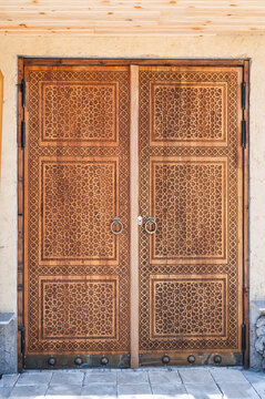 wooden door gate with a traditional oriental Uzbek carved pattern decorated with Islamic ornaments in Uzbekistan in Tashkent