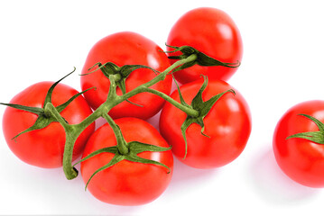 Branch of natural juicy tomatoes on a white background, selective focus