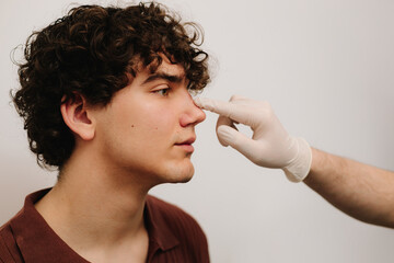Rhinoplasty consultation for man before plastic surgery to correct the nose size and shape....