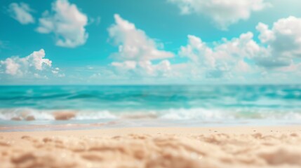 Obraz premium Tropical summer beach with golden sand, turquoise ocean, blue sky, and white clouds on a bright and sunny day