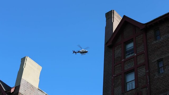 NYPD helicopter hovers over buildings in New York City during pro-Palestine protest at the Brooklyn Museum.