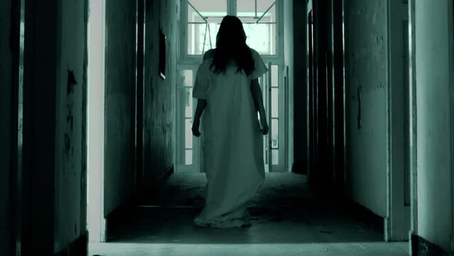 Horror scene of scary woman in shabby house hallway
