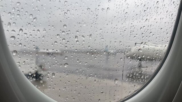 Rain outside of airplane window before flight take off 4k