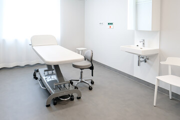 A doctor's office with a couch and a chair to examine a patient's health