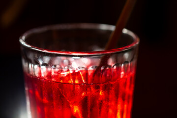 glass with ice, bright red cold drink, alcohol ice , party concept