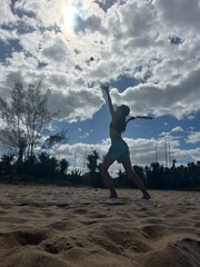 girl playing beach tennis on the beach