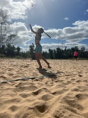 girl playing beach tennis on the beach
