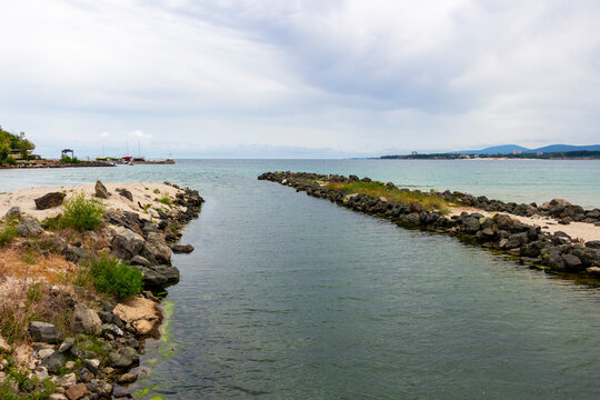 Devil's river or Dyavolska River, flowing into the Black Sea at Primorsko, Province of Burgas, Bulgaria under cloudy May sky