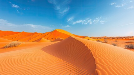 Fototapeta premium Majestic desert landscape with sweeping sand dunes and a clear blue sky