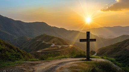 A Christian cross at the peak of a winding mountain pass, with the setting sun behind the hills creating a breathtaking golden bokeh that dramatizes the rugged terrain.