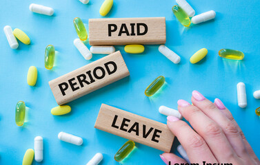 Paid Period Leave symbol. Concept words Paid Period Leave on wooden blocks. Beautiful blue...