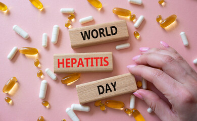 World Hepatitis Day symbol. Concept words World Hepatitis Day on wooden blocks. Beautiful pink...