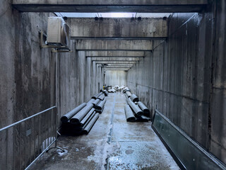 Concrete long rectangular tunnel with storage of building materials, bunker perspective view