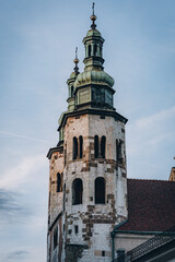 Vintage church towers with cross on green domes and arched windows in Krakow, Poland