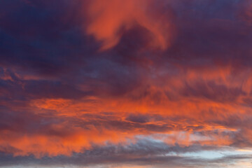 Dramatic fiery sunset, sky with fire of red and orange clouds, open air cloudscape