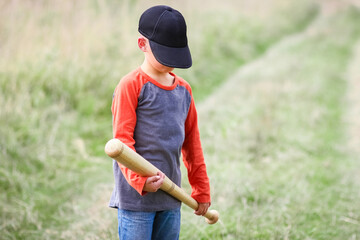 A Happy child with baseball bat on nature concept in park