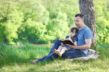 father and child reading the bible