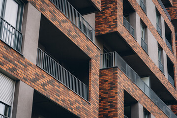 Modern European buildings facade with red and black brick for balcony decoration