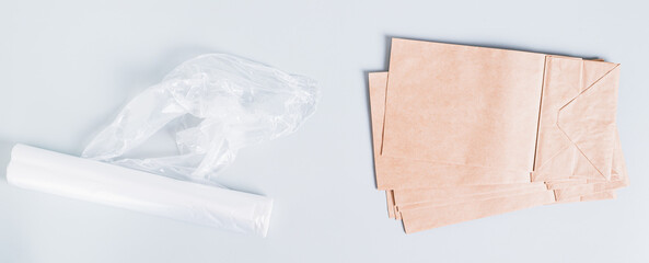 Eco friendly choice between plastic and paper bags on a blue background top view web banner