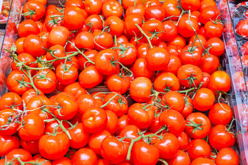 Close-up view of a shelf with red tomatoes in the vegetable section of a supermarket. Sweden.