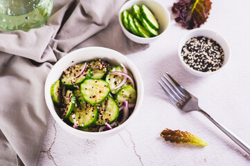 Healthy organic cucumber, quinoa and onion salad in a bowl on the table