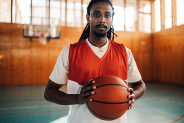 Muslim middle eastern male basketball player with a ball in his hands