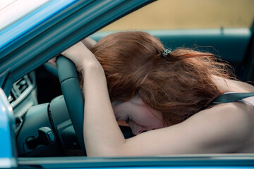 Stressed woman driver sitting inside her car