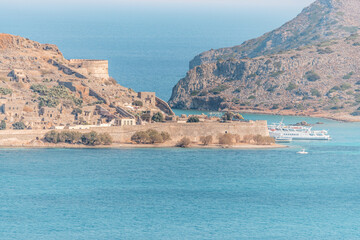 View of the Island of Spinalonga with calm sea on Crete, Greece.