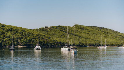 Obraz premium Many yachts moored off Dugi Otok island shore, idyllic coastal destination in Adriatic Sea, Croatia