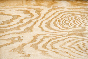 Sheet of plywood with wood grain in wavy lines pattern