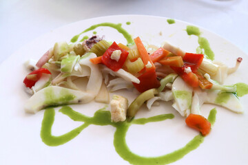 Plate with sliced ​​cuttlefish and vegetable gardener. Italian cuisine
