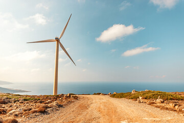 Wind turbines on a sunny day on sky background. Green energy generation concept.