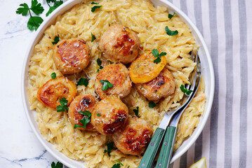 Baked lemon butter chicken meatballs with creamy orzo.top veiw