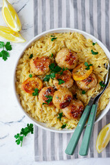 Baked lemon butter chicken meatballs with creamy orzo.top veiw