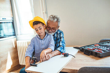 Grandfather and grandson working on diy project. You are a grandpas helping hand. Grandfather and...