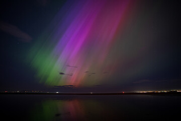 Northern lights / aurora over Dublin Bay in Ireland after G5 solar storm