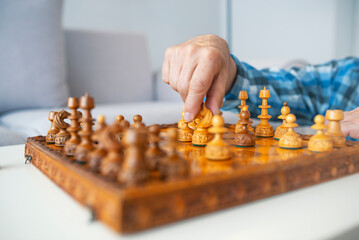 Hand of businessman playing chess game,competition success play,management or leadership concept.Business man moving chess figure with team behind - strategy or leadership concept