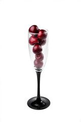 Ripe natural cherries, sweet cherries in a tall glass on a white background, close-up