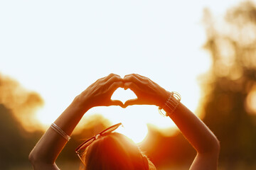 happy 40 years old woman in shirt showing heart hands