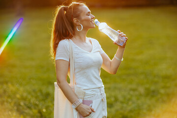 smiling modern female in white shirt with tote bag