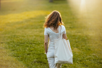 Seen from behind woman in white shirt walking