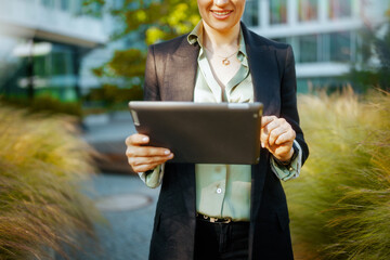 Modern business woman in business district using digital tablet