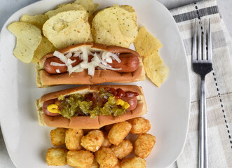 two hot dogs  with tater tots and