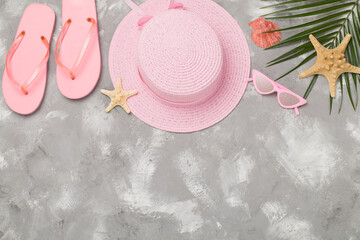 Flat lay with pink summer outfit on concrete background. Vacation concept
