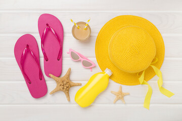 Flat lay with colorful beach accessories on wooden background. Vacation concept